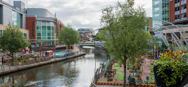 The Oracle Riverside. A river runs between bars and restaurants. 